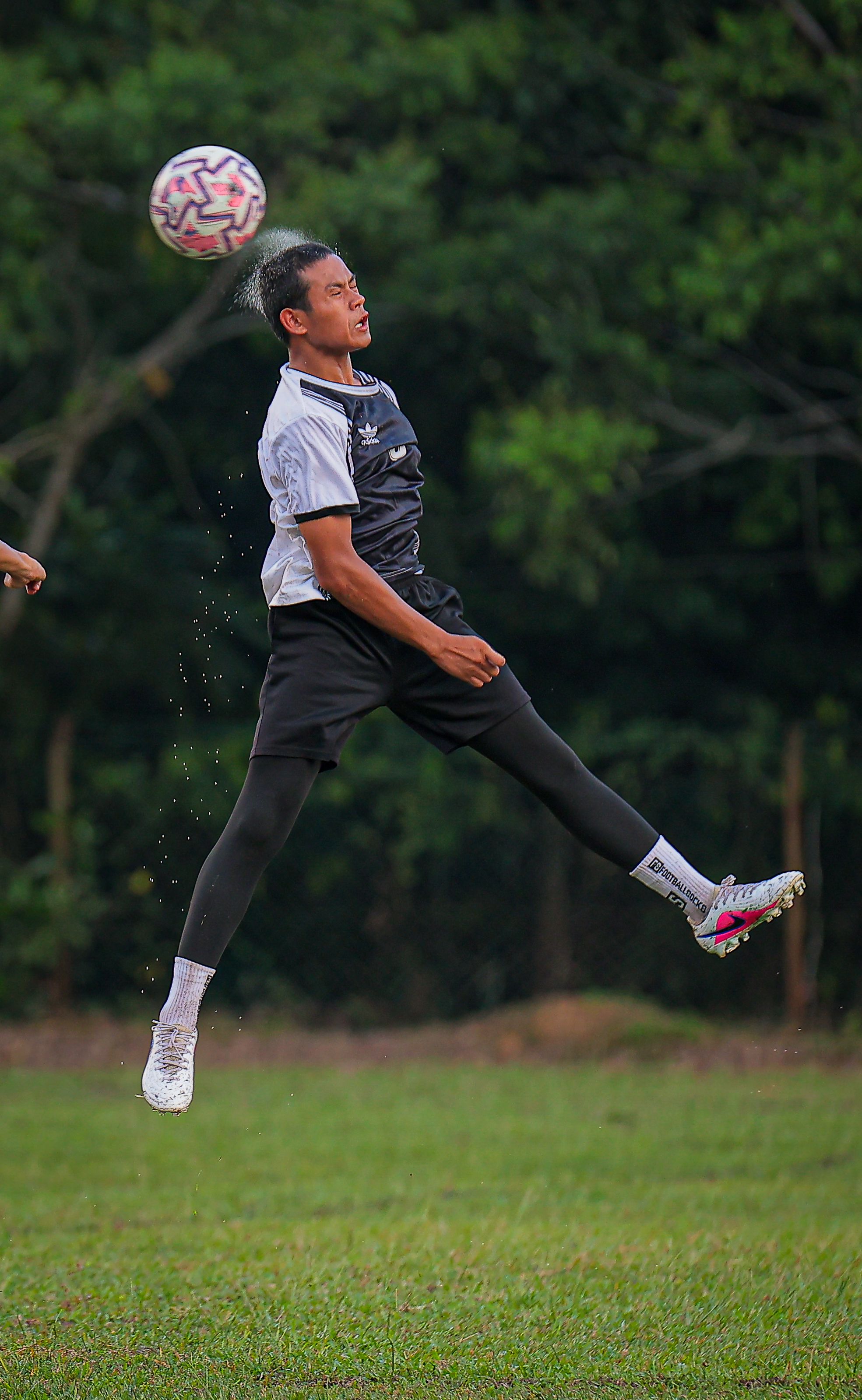Soccer Player Heading Ball in Mid-Air Action