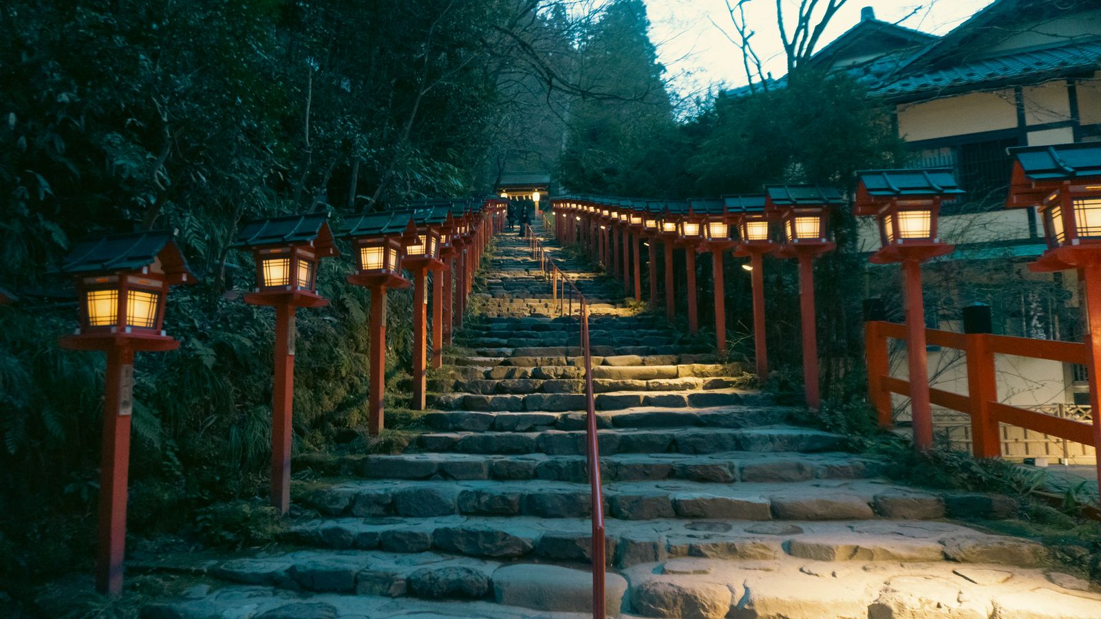 A lantern-lit lane leading to a Kyoto temple