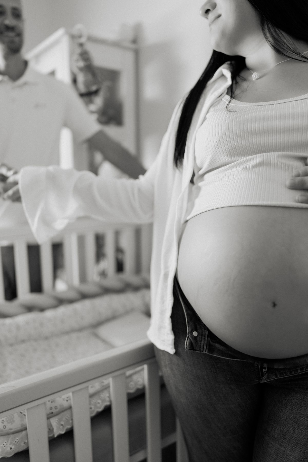 Expectant parents preparing a nursery together