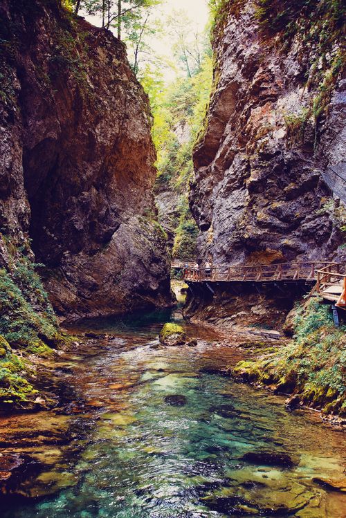 Free Breathtaking view of a gorge with a clear stream and wooden walkway, perfect for travel enthusiasts. Stock Photo