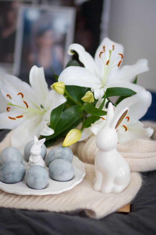 Free Elegant Easter setting with white lilies and ceramic bunnies, soft and inviting. Stock Photo