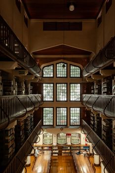 Elegant historic library with wooden shelves and large windows in São Paulo, Brasil.