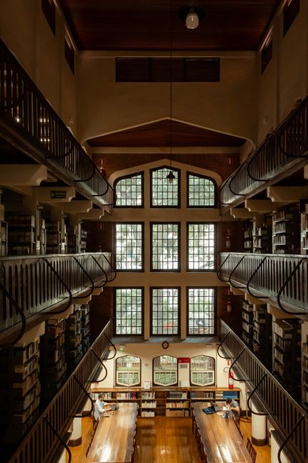 Elegant historic library with wooden shelves and large windows in São Paulo, Brasil.