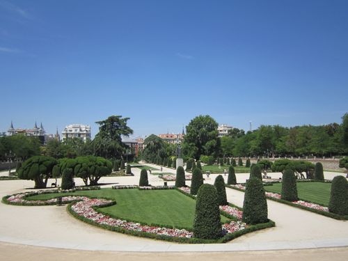 Free Lush green gardens with manicured hedges and trees in Buen Retiro Park, Madrid. Stock Photo