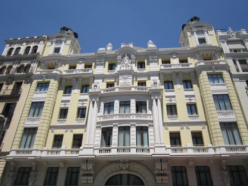 Free Detailed view of a historic building facade in Madrid, showcasing its classic architectural beauty on a sunny day. Stock Photo