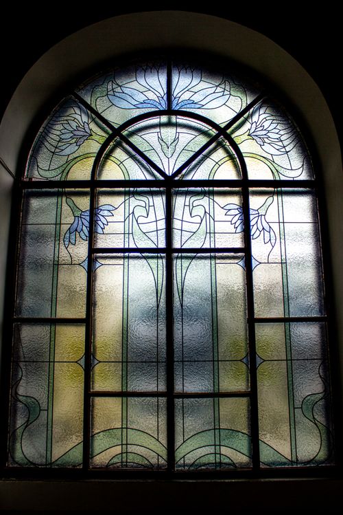 Free Art Nouveau style stained glass window emitting soft, diffused light. Perfect for architectural designs. Stock Photo