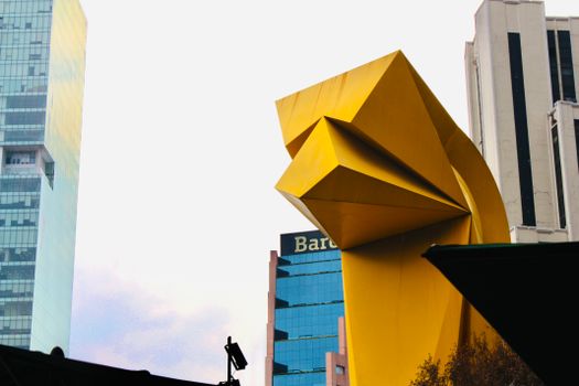 View of the iconic El Caballito sculpture amidst skyscrapers in Mexico City.