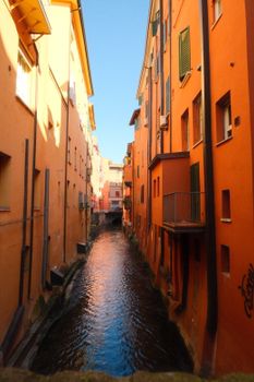 Captivating view of Bologna's vibrant orange canals in Emilia-Romagna, Italy.