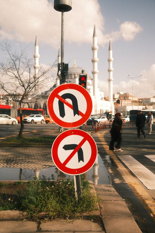 Free Street view with mosque in the background, featuring traffic signs prohibiting turns. Stock Photo