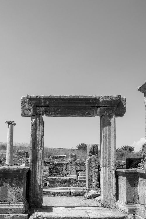 Free Monochrome image capturing ancient stone ruins and columns under a clear sky. Stock Photo