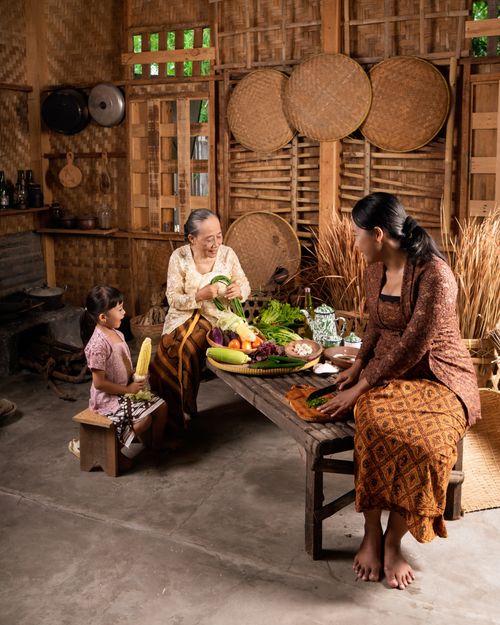 Free Three generations prepare traditional meal in rustic kitchen setting. Stock Photo