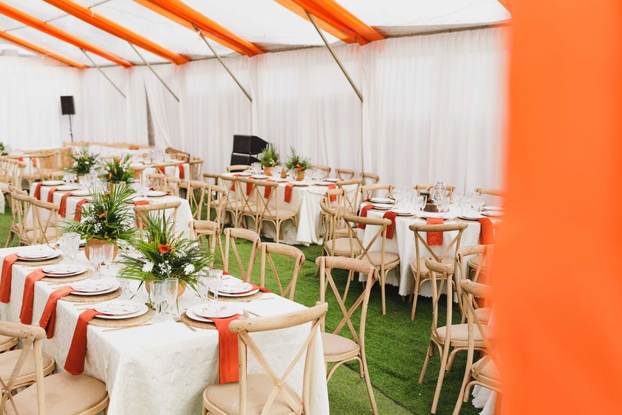 Concept: tented event setup with floral centerpieces