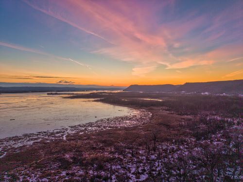 Free A breathtaking aerial view of a winter sunset over a frozen lake in Weaver, Minnesota. Stock Photo
