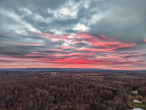 A breathtaking sunrise casting vibrant colors over a forest landscape in Kellogg, Minnesota.