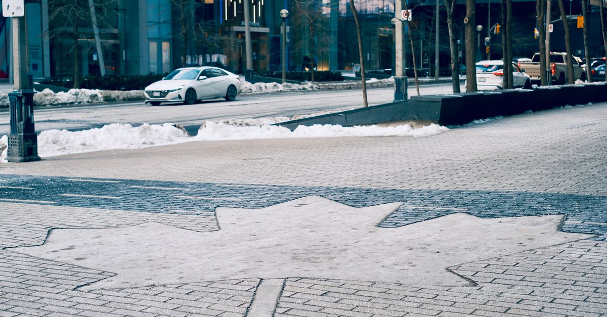 Canadian flag on a city street, reflecting Canadian capital moving to the United States in 2025