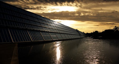 Free Black Solar Panel Near Calm Body of Water Stock Photo