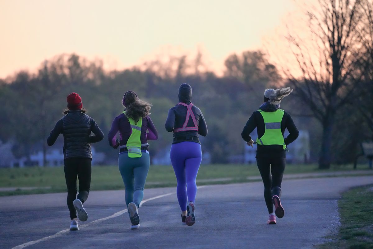Runners wearing layered active clothing outdoors