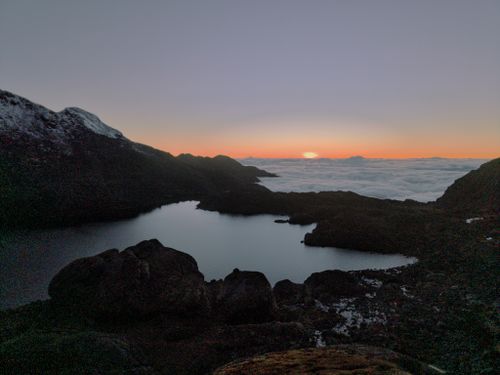 Free Stunning sunrise view over the Himalayan mountains with a serene lake in the foreground. Stock Photo