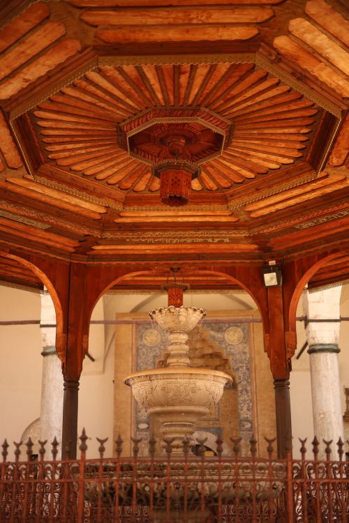 Free Intricate wooden pavilion ceiling with a decorative central fountain in a historic setting. Stock Photo