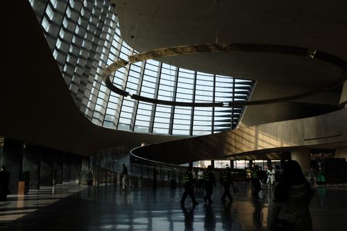 Free Spacious modern interior with unique spiral architecture and large windows highlighting light and shadows. Stock Photo