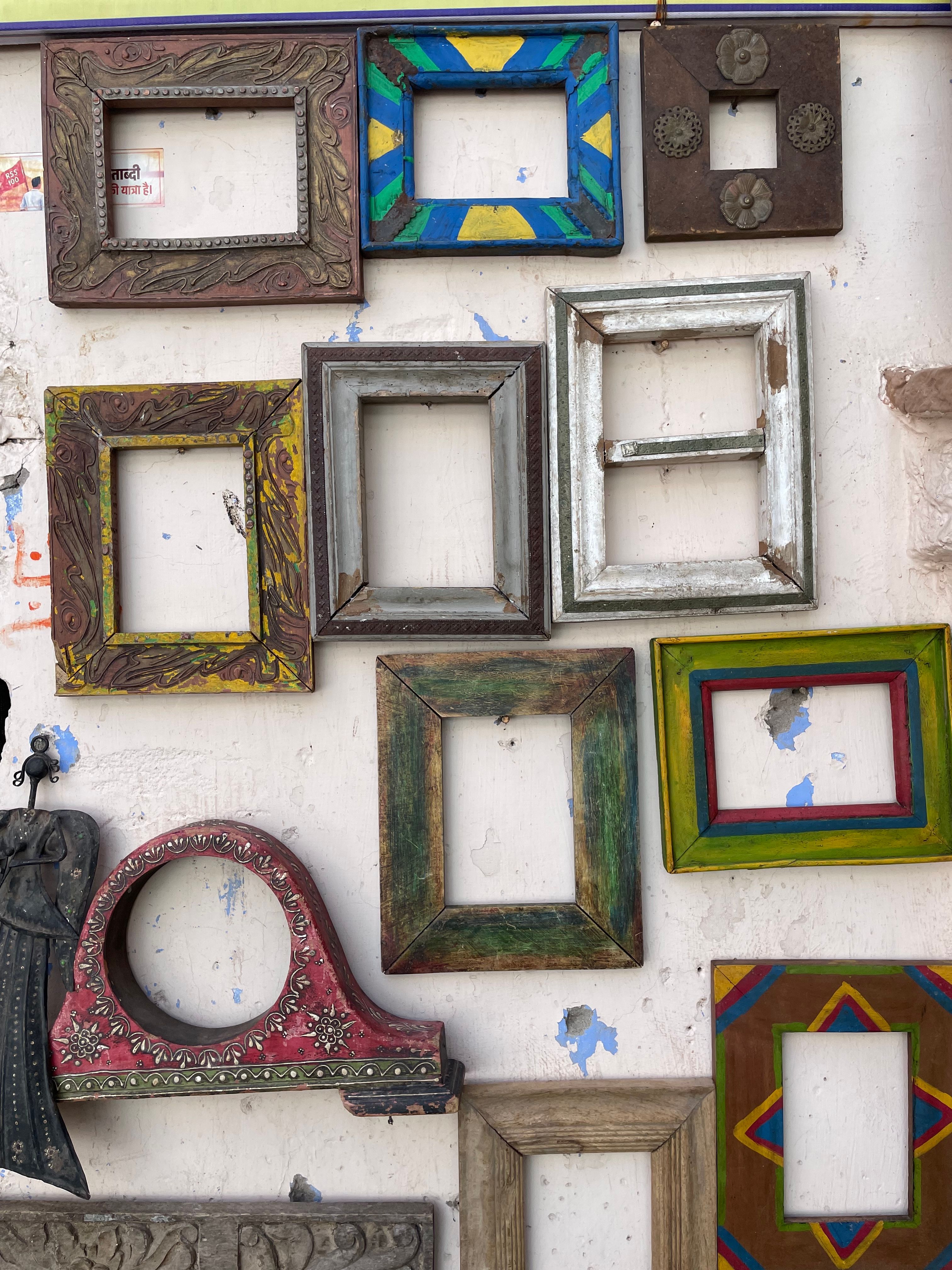 Grid of colorful framed prints arranged on a wall