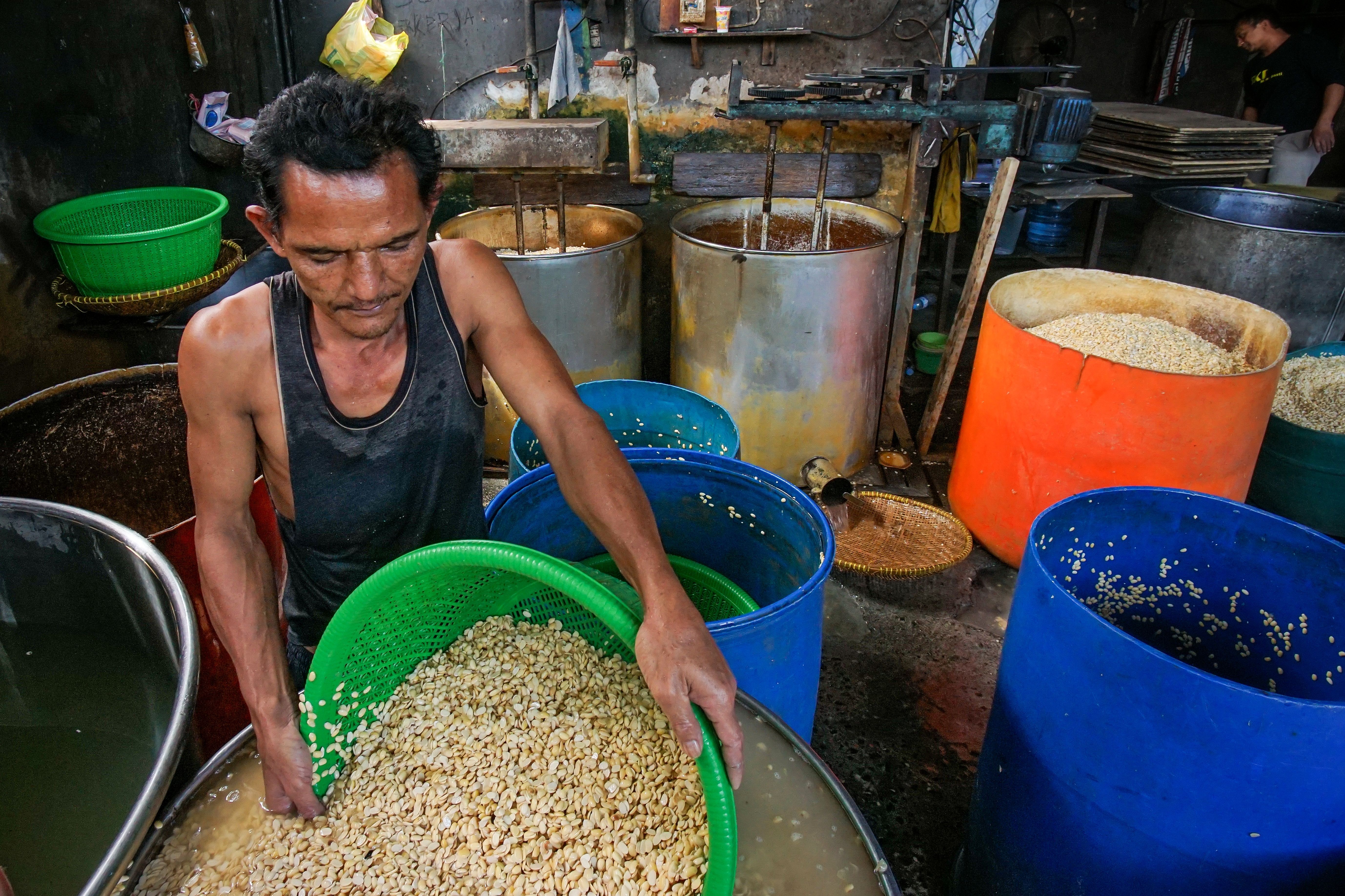 Man processing tofu in a traditional factory in Baleendah, Indonesia.
