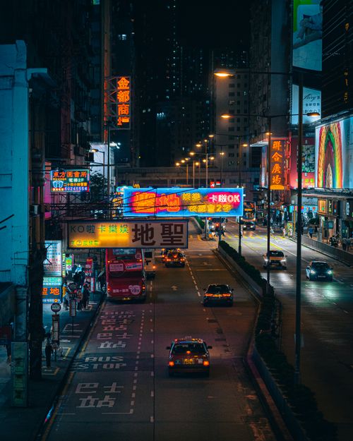 Free Colorful cityscape of Hong Kong at night filled with neon signs and traffic. Stock Photo