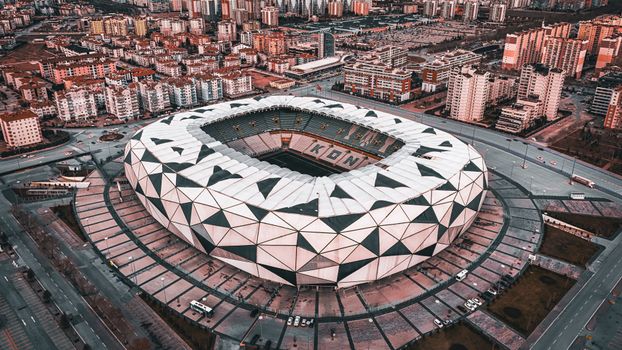 A stunning aerial view of the geometric design of Konya Stadium in Türkiye, showcasing urban architecture.