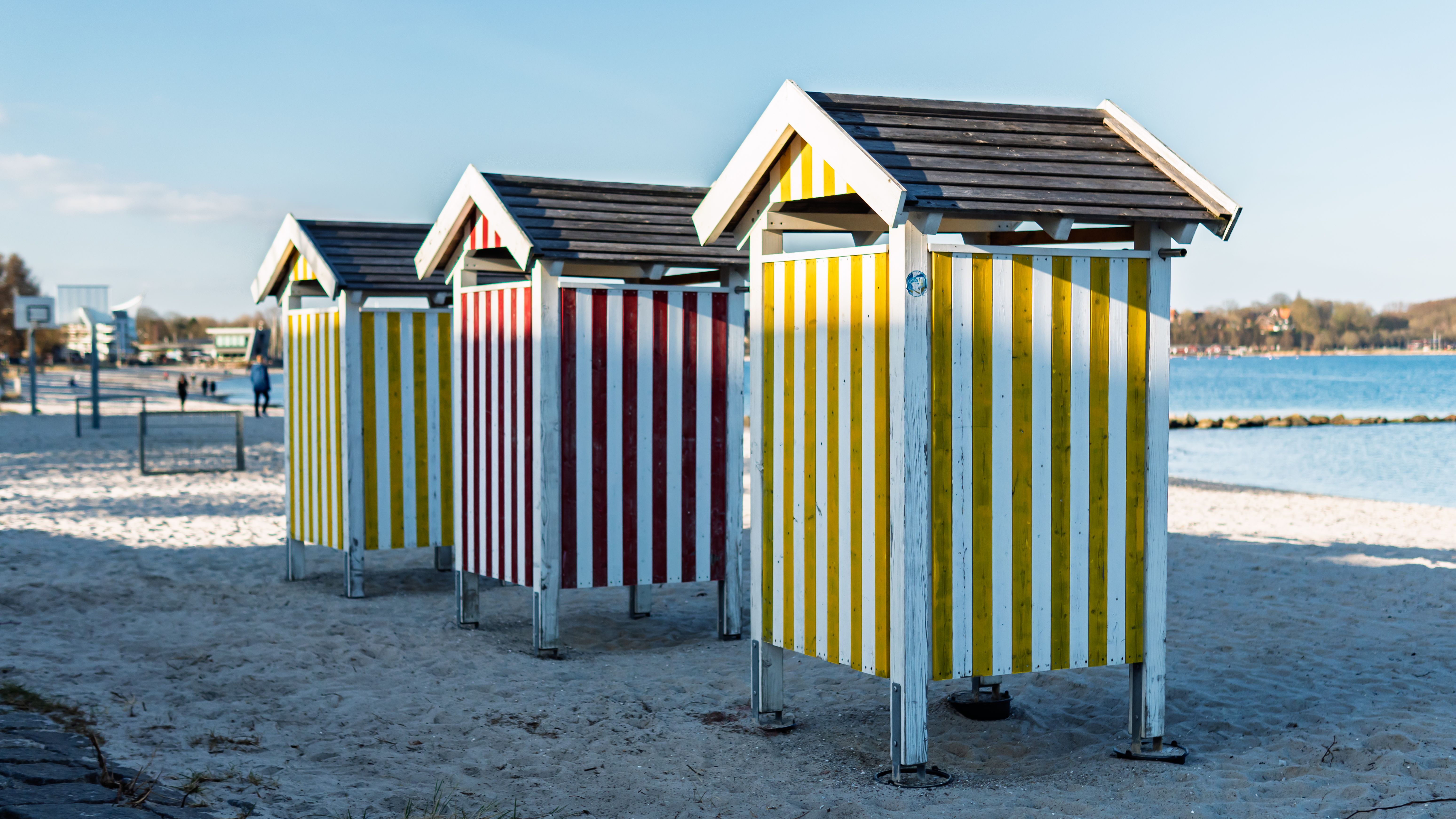 Colorful Beach Huts on a Sandy Shoreline · Free Stock Photo