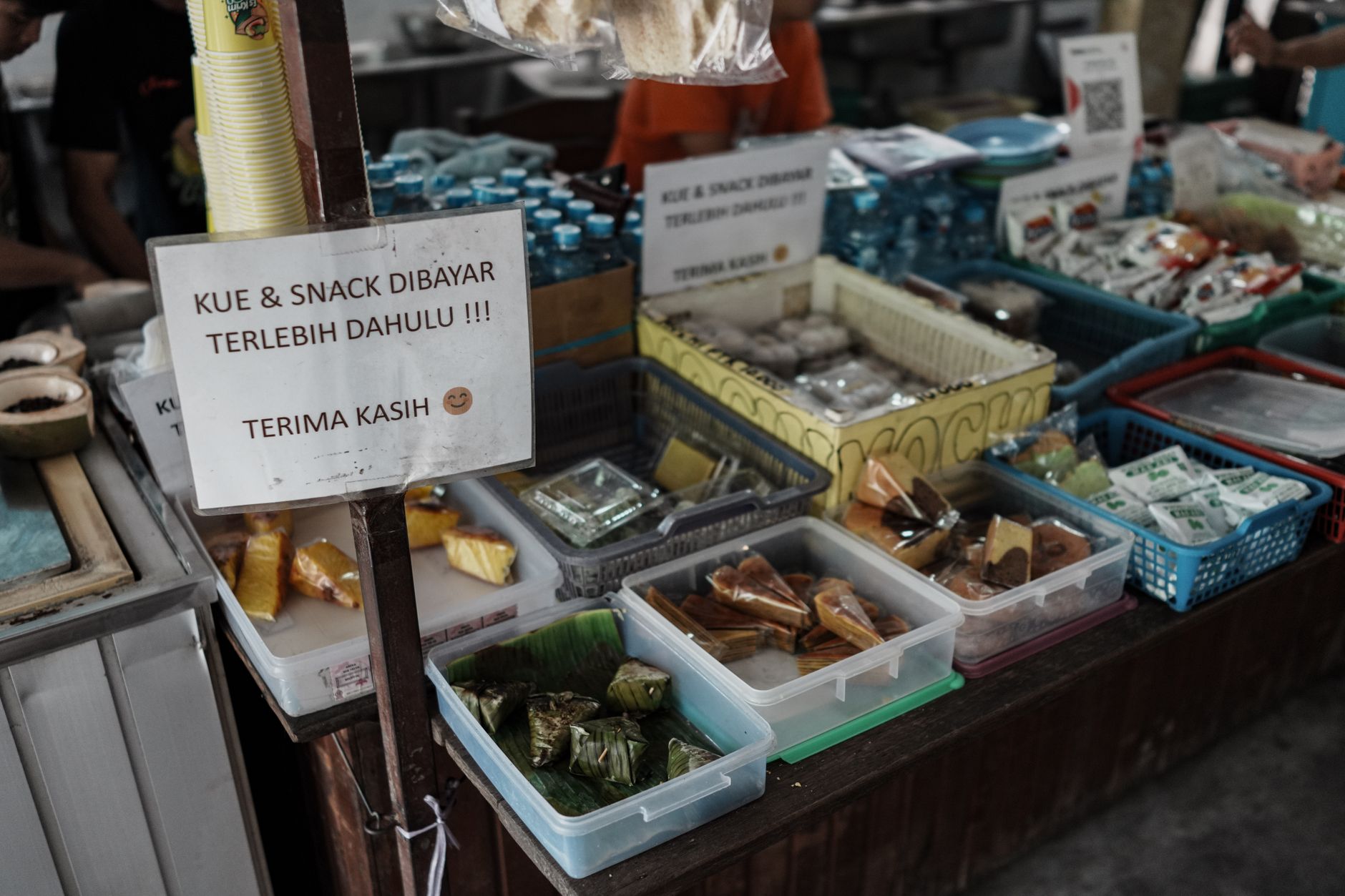 Colorful array of Indonesian snacks at a traditional market in Pontianak, Indonesia.