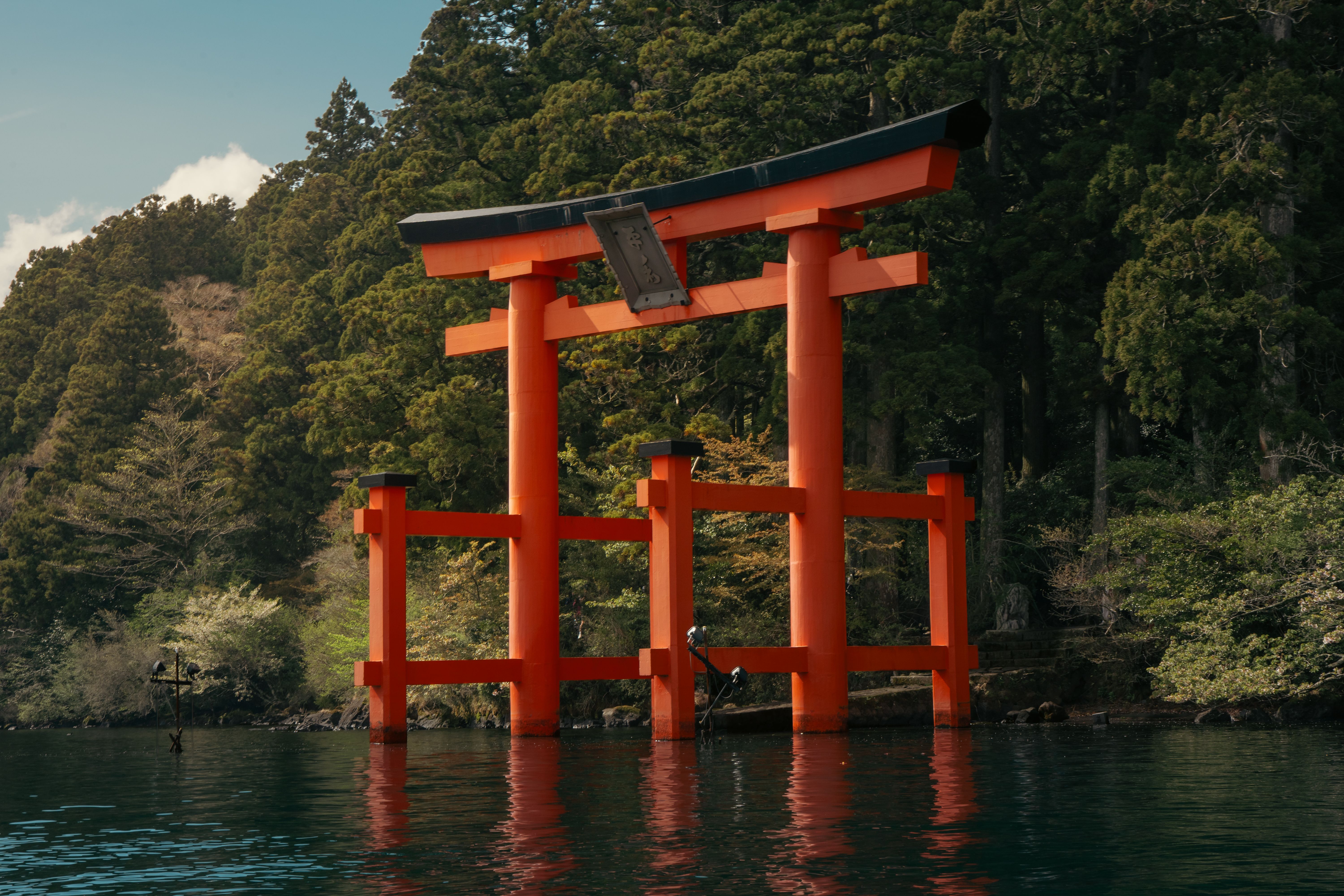 Magnifique vue du torii rouge emblématique du lac Ashi, à Hakone, entouré d'une végétation luxuriante.
