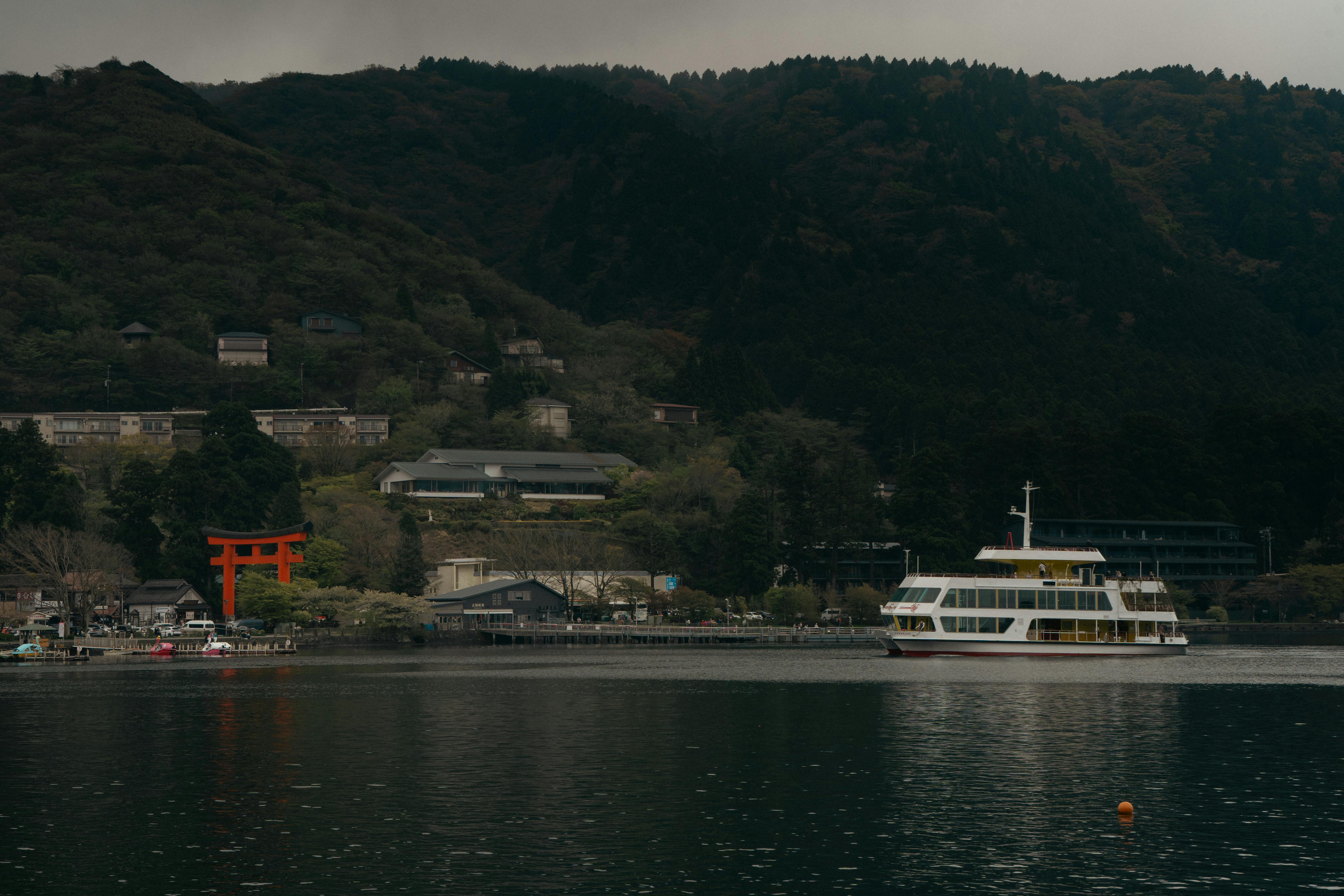 Scenic view of a ferry on Lake Ashi with the iconic torii gate of Hakone Shrine, prefecture of Kanagawa, Japan.