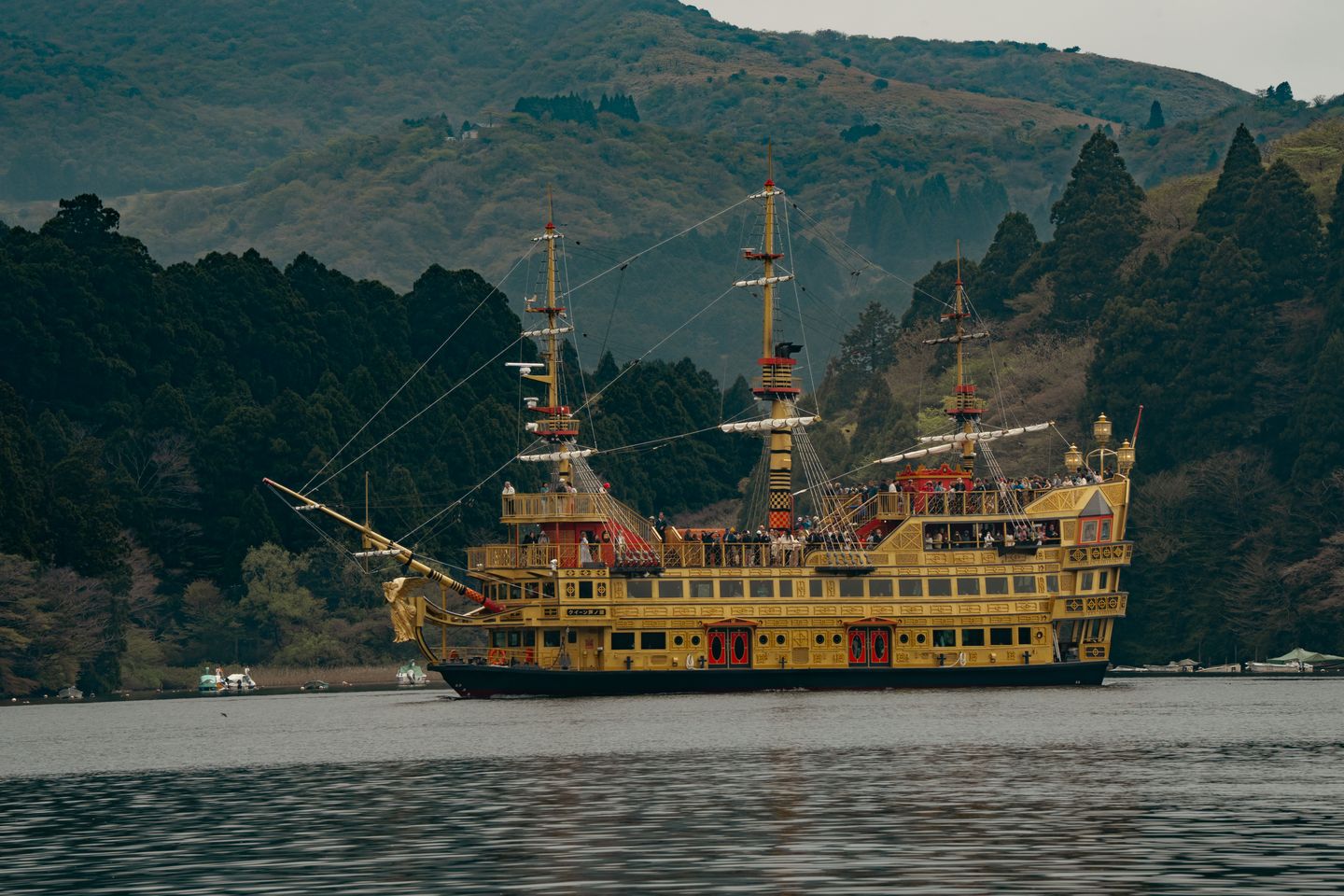 Vintage-style pirate ship cruising on Lake Ashi amid Hakone's scenic mountains, Japan