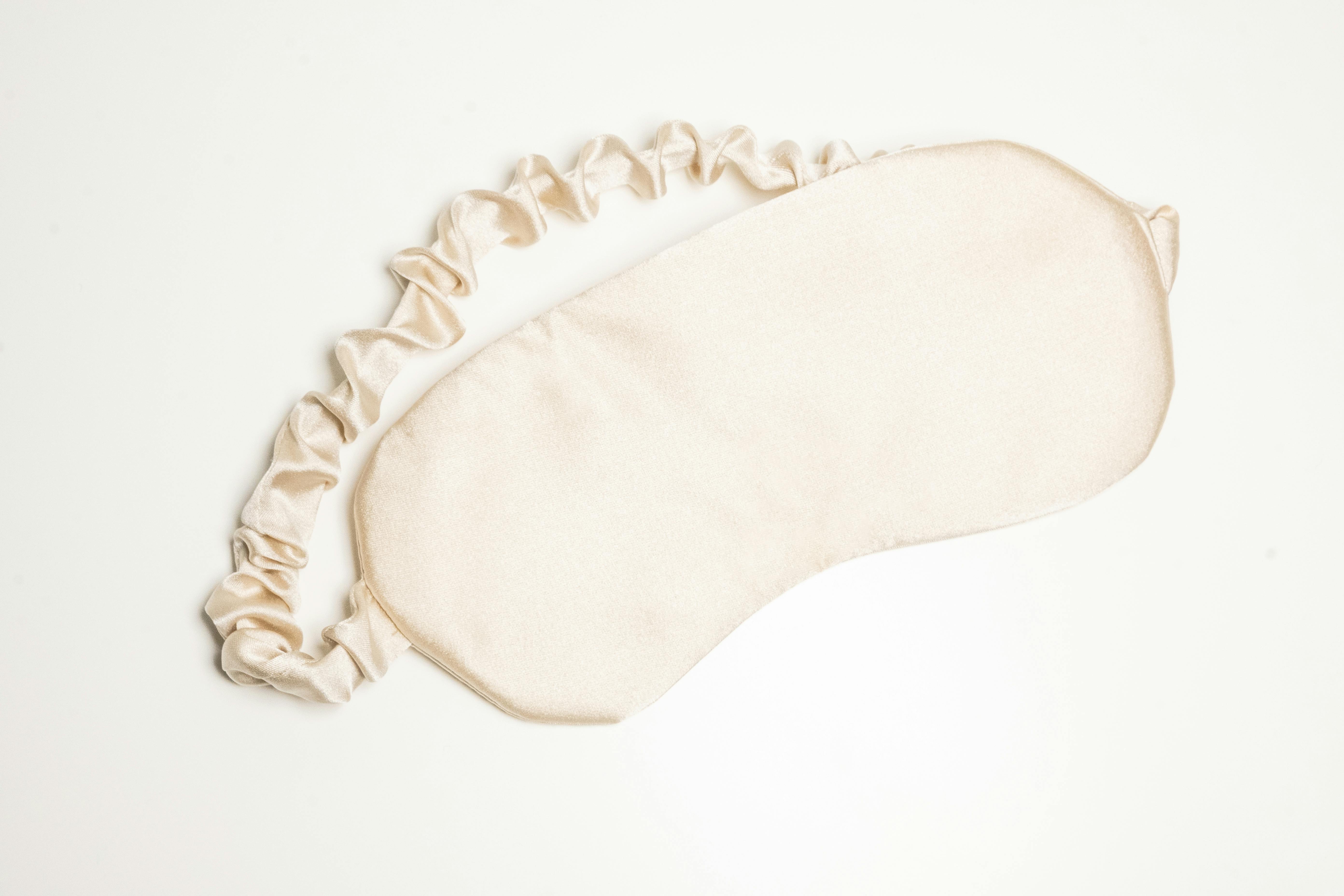 Luxurious silk sleeping mask displayed against a clean white background, perfect for beauty and relaxation themes.