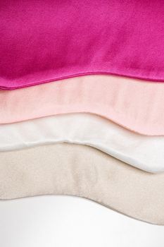 Close-up of luxurious silk eye masks stacked in vibrant colors for beauty and relaxation.