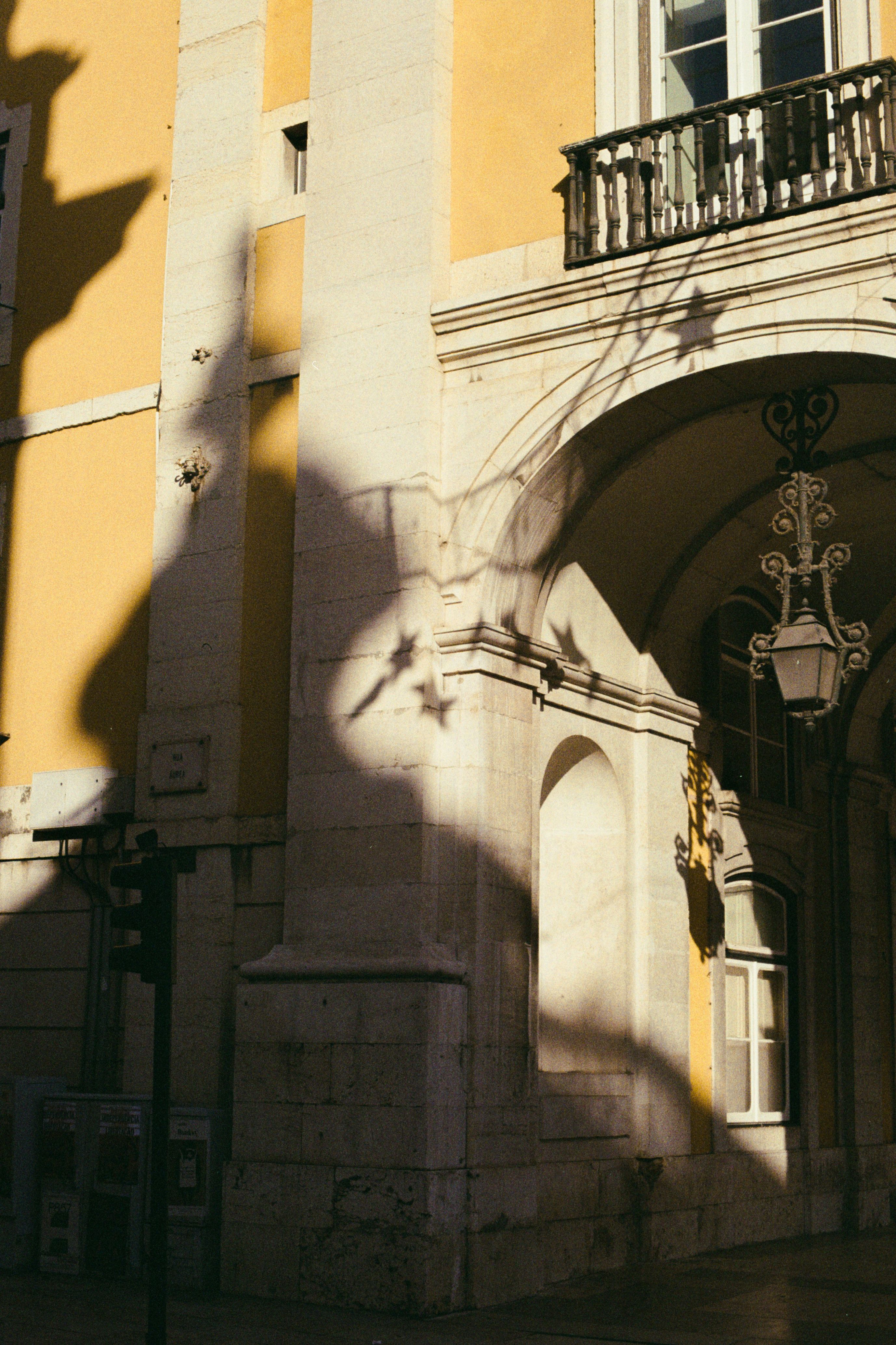 Elegant shadows cast on Lisbon's historic architecture at daytime.