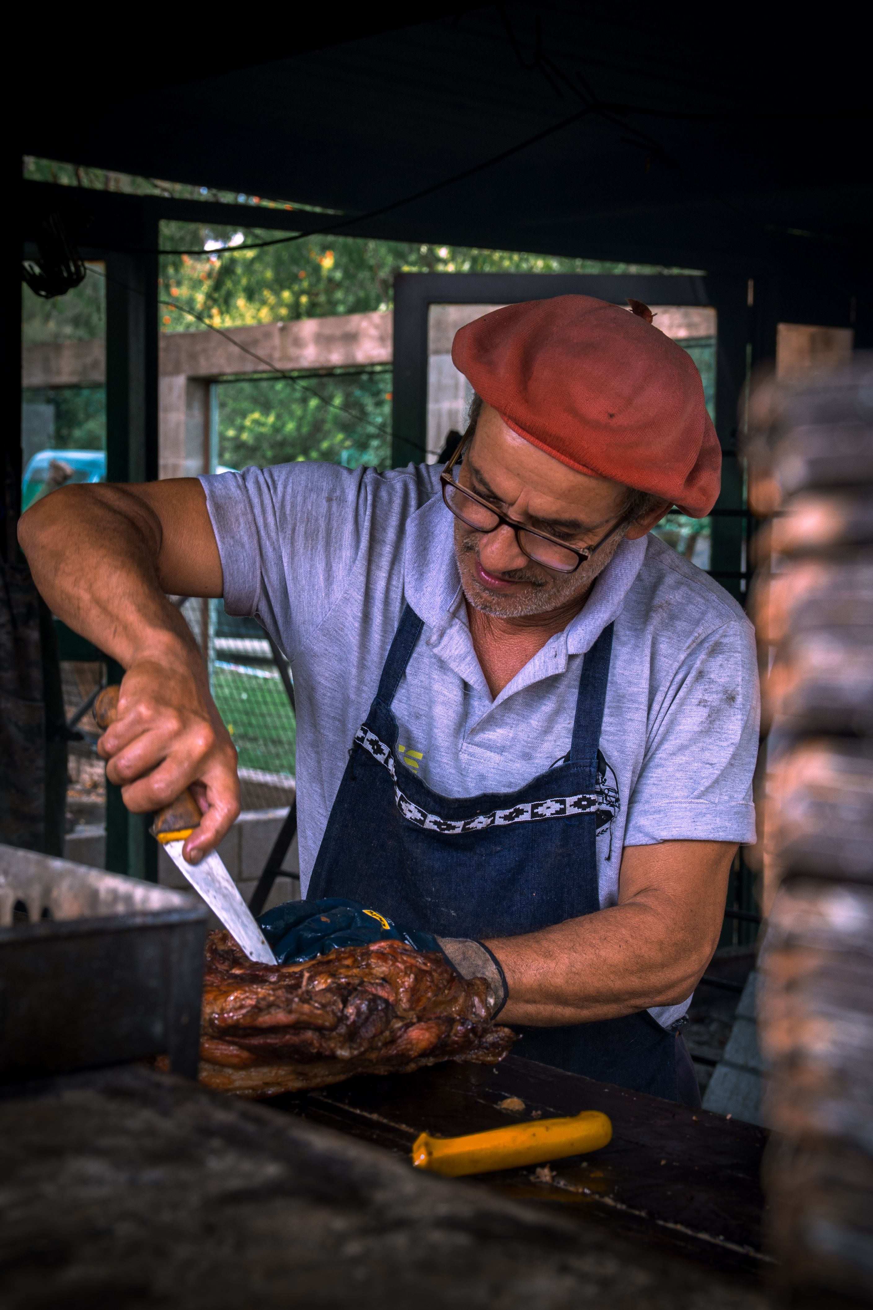 Chef Carving Roast Meat at Outdoor Market Stall · Free Stock Photo