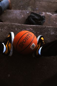 A casual scene with a basketball and sneakers on outdoor steps, emphasizing sports leisure.