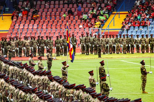 Free A vibrant military parade at a stadium with soldiers in uniform holding national flags. Stock Photo