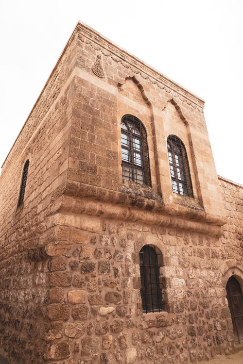 Free A historic stone building in Mardin, Turkey with intricate architectural details. Stock Photo