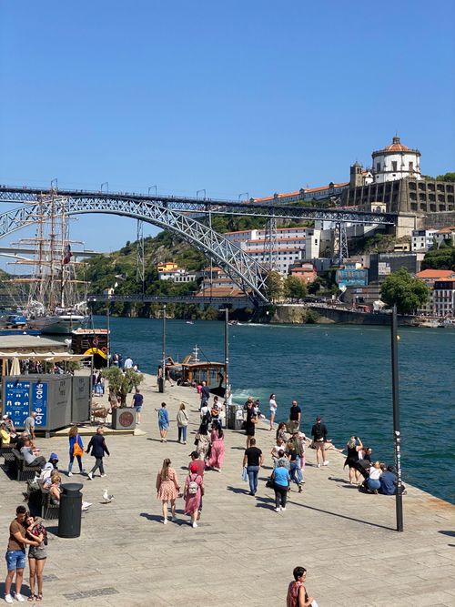 Free Vibrant day at Porto's riverside with the iconic Dom Luís I Bridge in view. Perfect for travel and architecture themes. Stock Photo