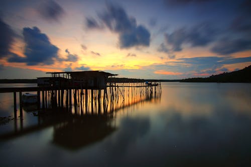 Free Brown Wooden Dock Silhouette during Golden Hour Stock Photo