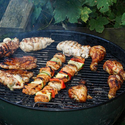 Skewers and chicken over a charcoal grill — photo by Thomas Fritscher on Pexels