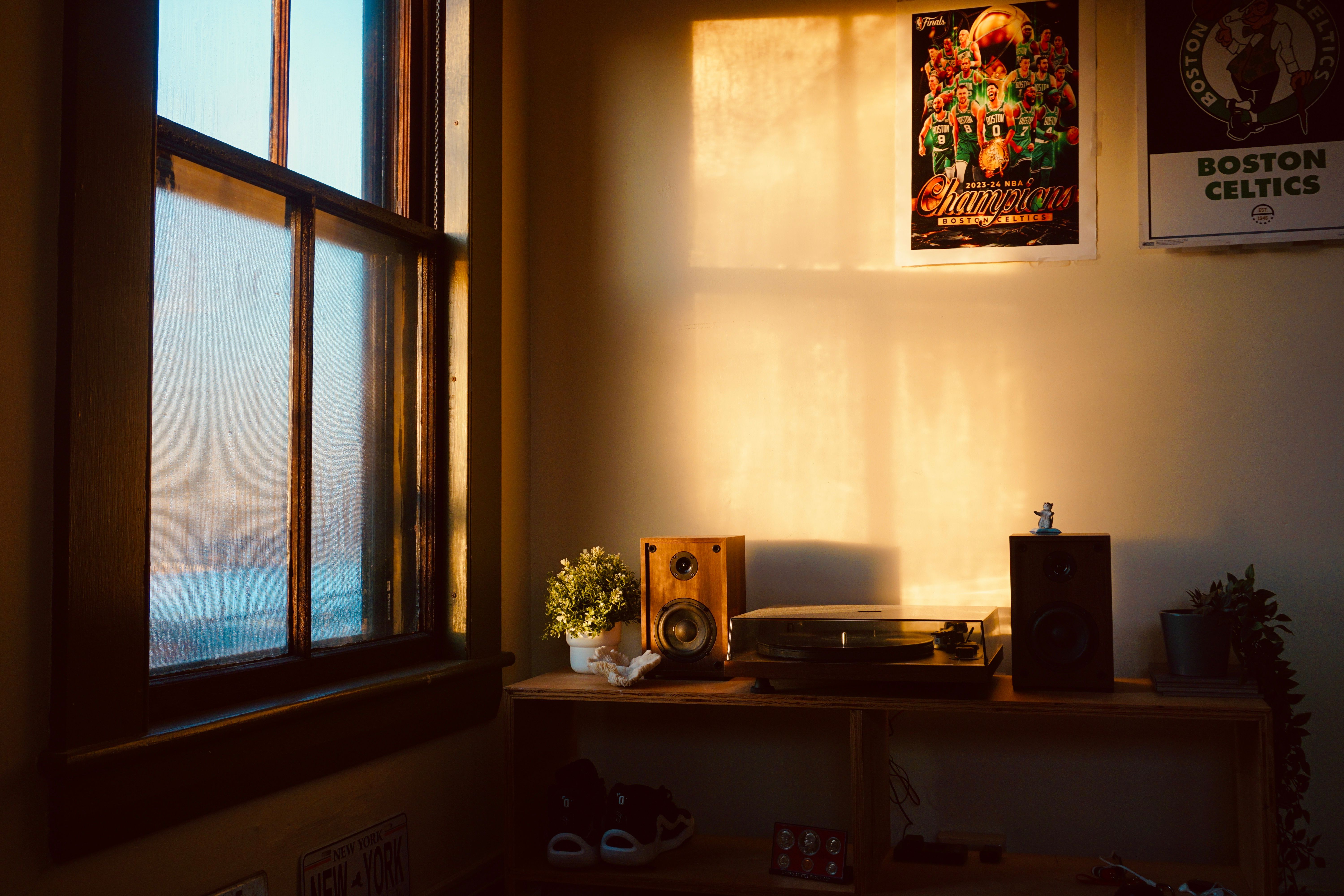 A modern NBA locker room with a quiet corner featuring a couch, plants, and a sign that says 