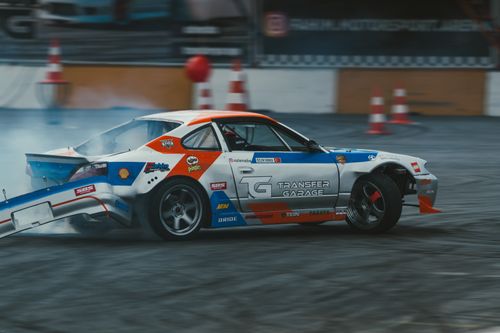 Free A dynamic action shot of a colorful drift car racing on an indoor track, showcasing speed and motion. Stock Photo