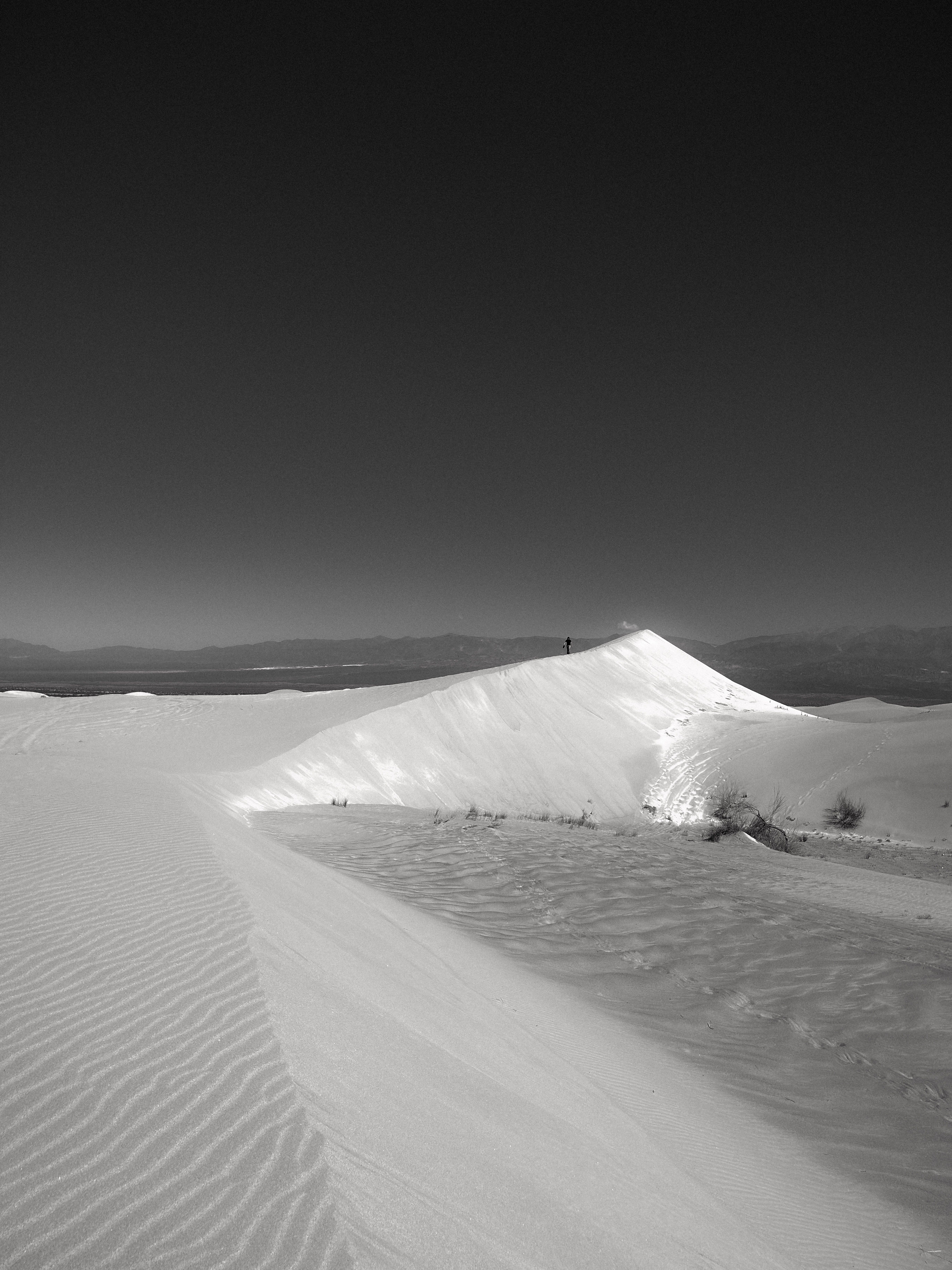 Black and white photo of dramatic sand dunes under a clear sky in Catamarca, Argentina.