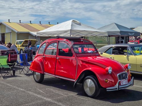 Free Classic red Citroën 2CV at an outdoor vintage car show with other retro vehicles. Stock Photo