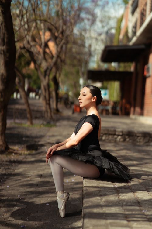 Free Ballet dancer in black tutu performs outdoors showcasing elegant pose. Stock Photo