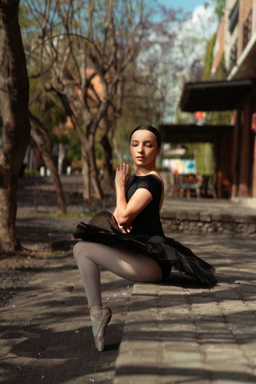 Free Ballerina in a tutu gracefully posing on a street during spring. Stock Photo