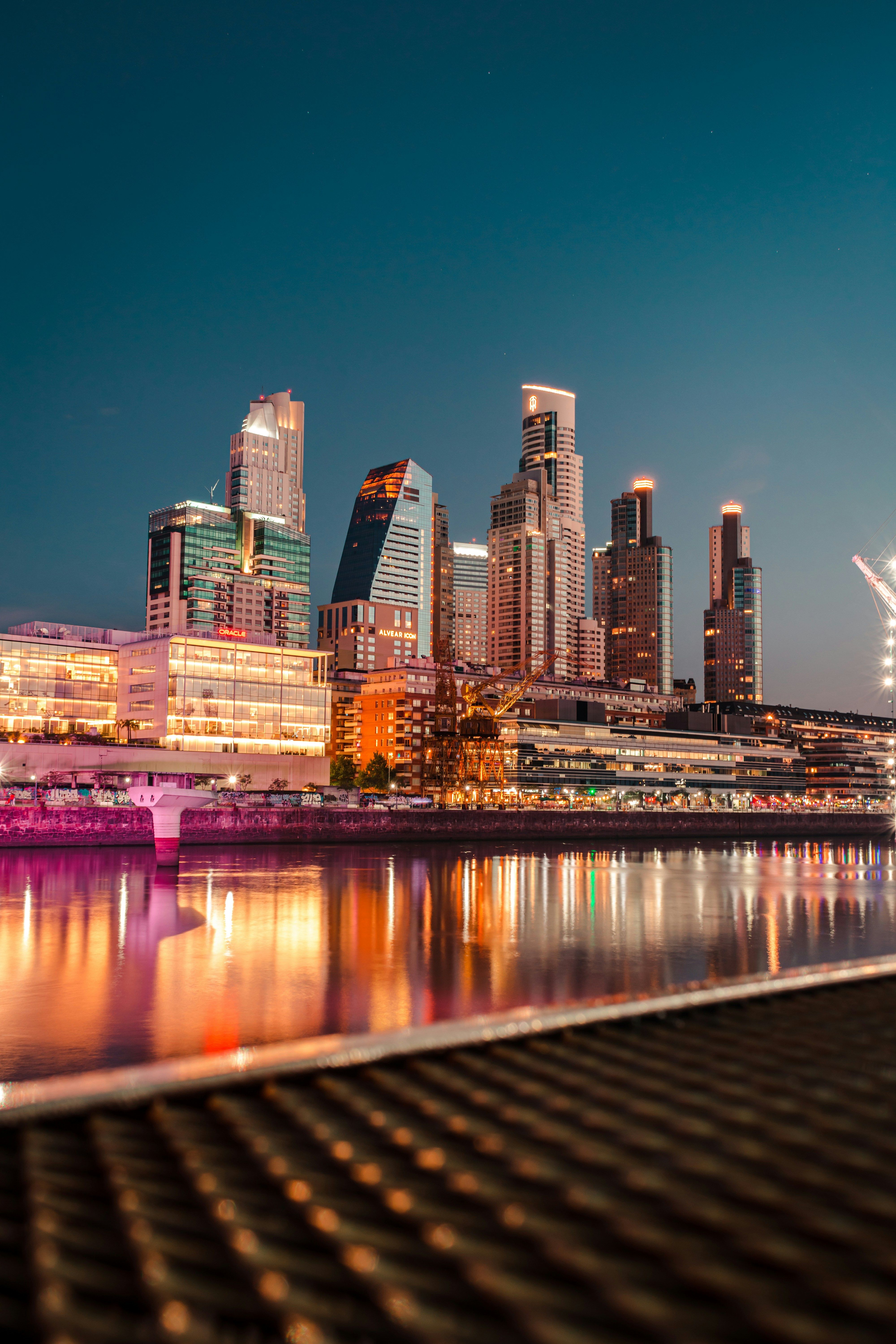 Beautiful city skyline reflecting in the river at twilight, vibrant urban scene.
